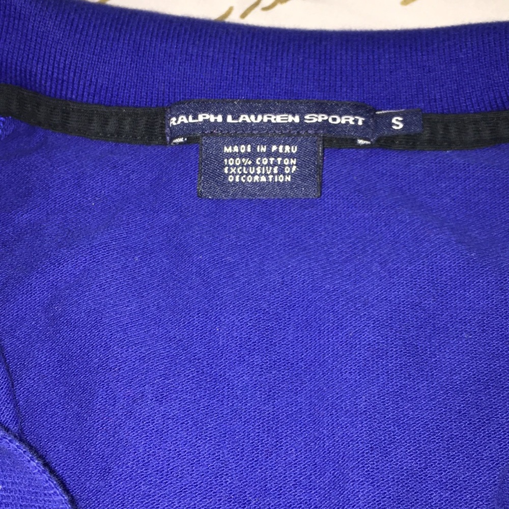 Long sleeve blue and black polo shirt.